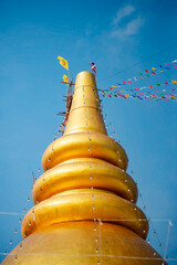 Golden pagoda at the temple in the blue sky, Thailand