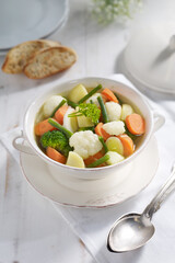 Homemade Vegetable Soup with Fresh Ingredients in a Rustic Setting