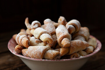 Sweet homemade mini croissants sprinkled with powdered sugar.