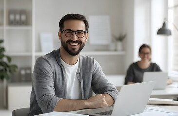 Obraz premium A smiling man and woman sitting at an office desk, using laptops