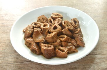 braised slice pork innards in black Chinese herb soup on plate 