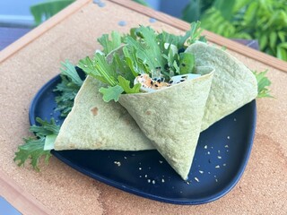 Boiled egg with mixed salad in spinach funnel tortilla
