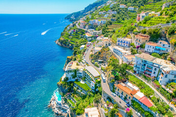 Fototapeta premium Amalfi on Amalfi Coast, Italy. Aerial photo of famous city Amalfi located on Amalfi Coast with blue sea water and beautiful colorful houses on the cliff