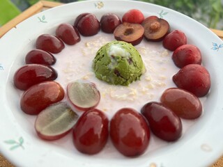 Strawberry overnite oat meal with Red bean green tea Greek yogurt with cherry and grapes