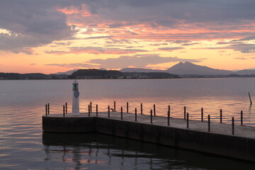 Obraz premium Lighthouse under Soft Sunset Sky with Color Gradient and Clouds in Japan