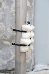A makeshift solution with foam and zip ties securing an object to a metal pole, highlighting ingenuity in everyday fixes
