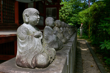 A row of Buddha statues near Takao Yakuoin Temple