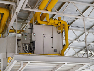 Ceiling with ventilation pipes and lights in industrial building