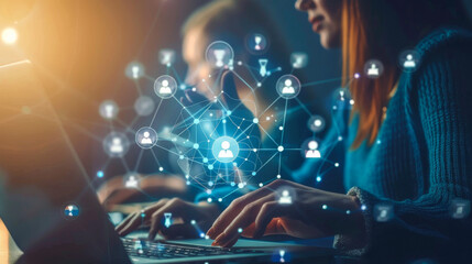 A young office employee works in a modern office at a laptop with global network technologies. Business concept.