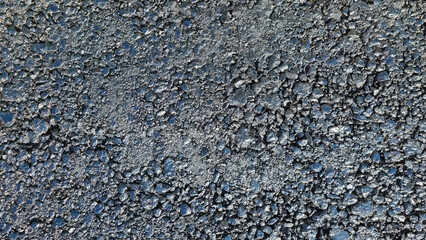 New laid asphalt road, large crushed stone.  Close-up. Background.