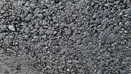 New laid asphalt road, large crushed stone.  Close-up. Background.