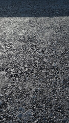 New laid asphalt road, large crushed stone.  Close-up. Background.