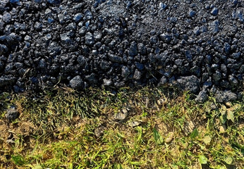 new asphalt road texture with green grass for  background. Top view. Selective focus