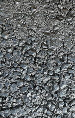 New laid asphalt road, large crushed stone.  Close-up. Background.