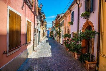 A view down a quiet, colourful street in the village area of San Giuliano in Rimini, Italy in summertime