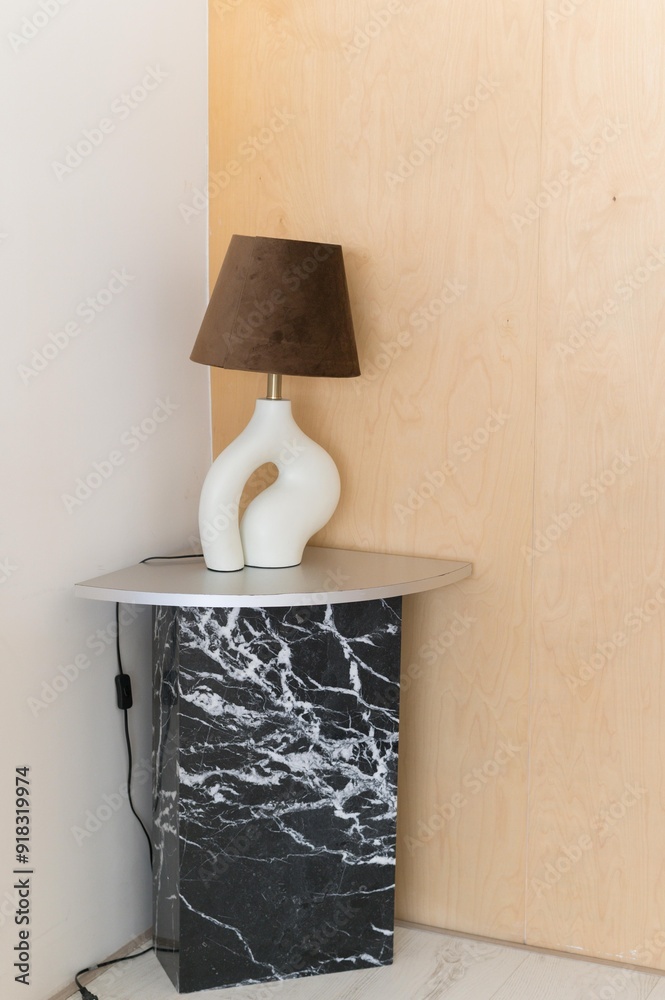 Fototapete a modern lamp with a unique design sits on a stylish marble side table, creating a contemporary and 