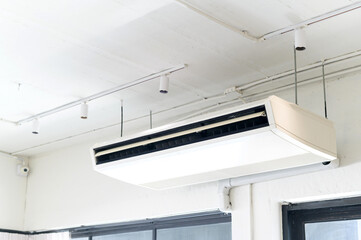 Air conditioning unit mounted on the ceiling, providing a cool and comfortable atmosphere. The...