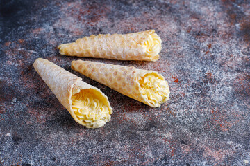 Homemade nut shaped russian soviet cookies and wafer rolls with pastry cream.