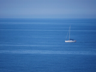 Fototapeta premium A sailboat yacht sails into the sea, aerial view