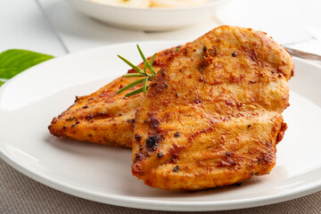 Air Fryer chicken breast seasoning with garlic,paprika,salt and pepper in a plate.Healthy oilless cooking.Diet menu.