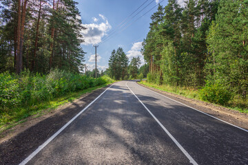 A road with a clear blue sky above it