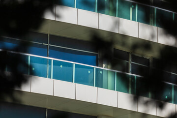 City view on a sunny day. Modern building and houses against the blue sky.