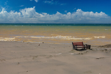 Wooden benches and sun loungers for relaxing on the embankment near the sea, public places