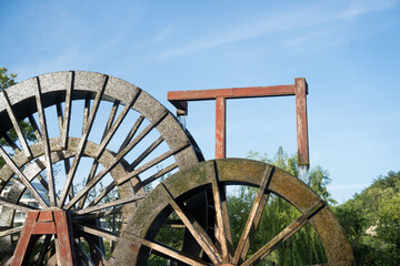 old wood wheels in blue sky