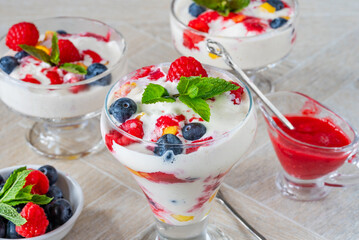 Vanilla ice cream dessert with fresh fruit and raspberry coulis
