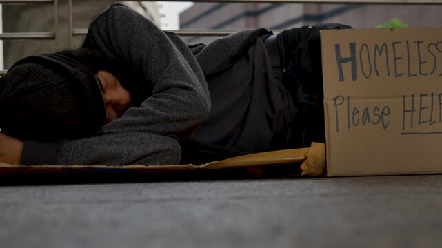 Homeless man praying to god for help people poverty beggar man asking for money job and hoping help in helpless dirty city sitting on street. Close up hands of homeless man praying beggar in city life
