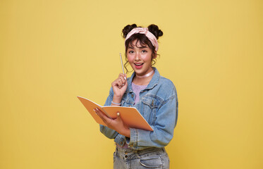 back to school. happy smiling young Asian college student with notebook think something ready to...