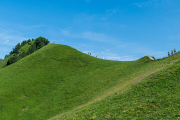 Obraz premium The Stoos hike in summer offers breathtaking views of the Swiss Alps, lush green meadows, and serene lakes. The trail is accessible yet challenging, with panoramic vistas that make every step rewardin