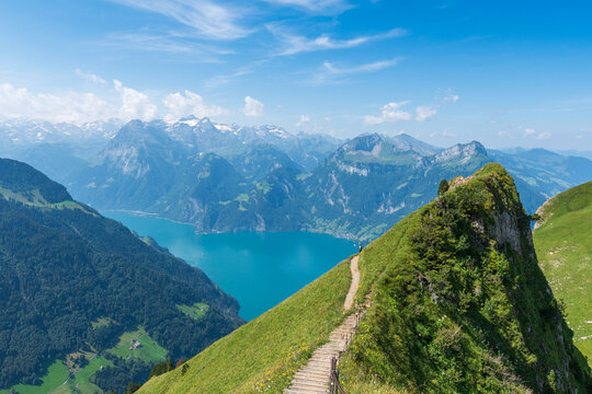 The Stoos hike in summer offers breathtaking views of the Swiss Alps, lush green meadows, and serene lakes. The trail is accessible yet challenging, with panoramic vistas that make every step rewardin