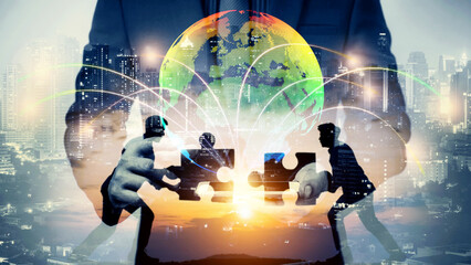 double exposure of businessman using cellphone connecting globe simulation with Silhouette of Two...