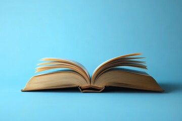 Open book with flipping pages against a bright blue background, knowledge, reading, literature, education, study.