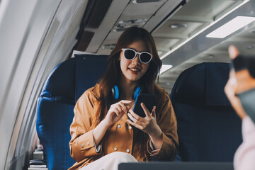 A young Asian woman, seated as an airplane passenger, contemplates dollar bills, reflecting on lucrative opportunities and aspirations towards billionaire status.