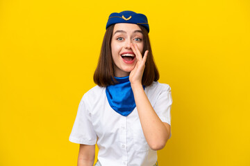 Airplane stewardess Ukrainian woman isolated on yellow background with surprise and shocked facial expression