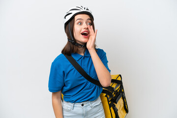 Young Ukrainian woman with thermal backpack isolated on white background shouting with mouth wide open to the lateral