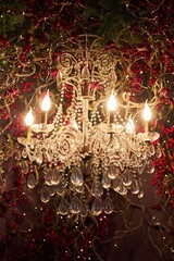 Stylish interior of a room decorated for the new year or Christmas. Close-up of a glowing chandelier