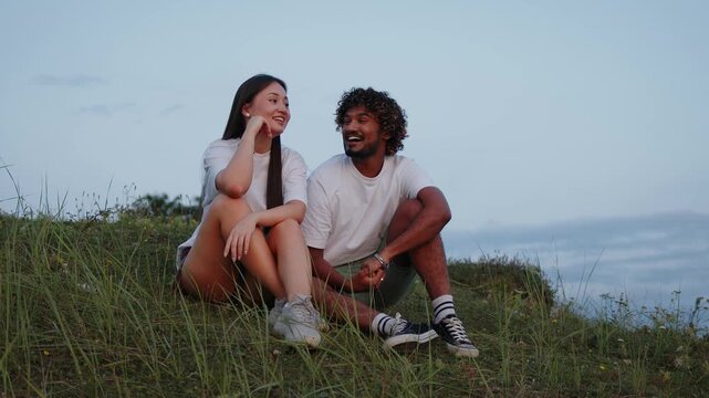 Happy smiling multi-ethnic couple in love enjoying a romantic date together in nature.