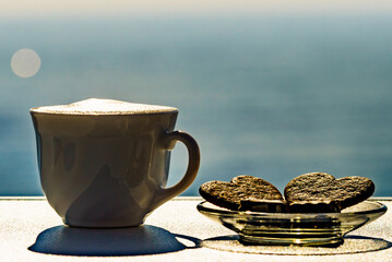 Coffee cup on sea shore. Travel outdoor picnic.