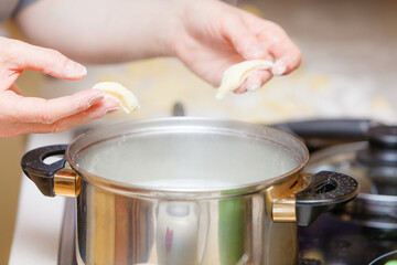 Hands cooking noodles