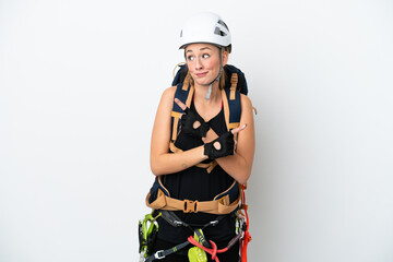 Young caucasian rock climber woman isolated on white background pointing to the laterals having doubts