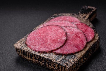 Delicious smoked salami sausage sliced with salt, spices and herbs