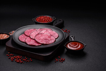 Delicious smoked salami sausage sliced with salt, spices and herbs