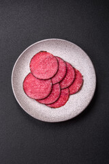 Delicious smoked salami sausage sliced with salt, spices and herbs