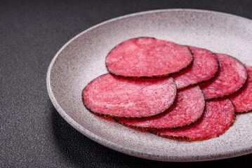 Delicious smoked salami sausage sliced with salt, spices and herbs