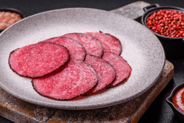Delicious smoked salami sausage sliced with salt, spices and herbs