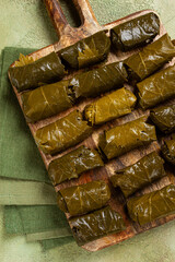 dolma, minced meat with rice, in grape leaves, minced meat rolls, on a chopping board, top view, no people,