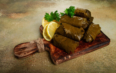 dolma, minced meat with rice, in grape leaves, minced meat rolls, on a chopping board, top view, no people,
